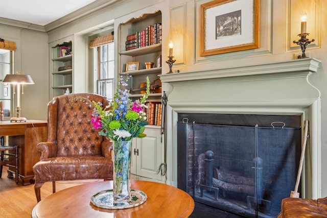 84 S Main St, Hanover, NH 03755 - living area featuring a fireplace, wood finished floors, crown molding, and built in shelves