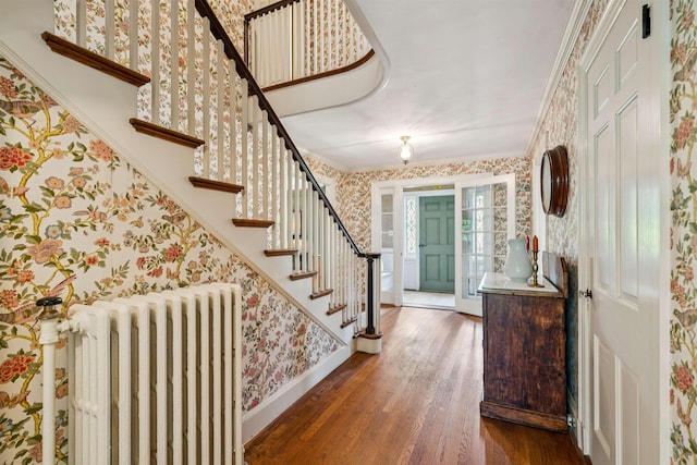 84 S Main St, Hanover, NH 03755 - foyer featuring radiator heating unit, wallpapered walls, wood finished floors, crown molding, and stairway