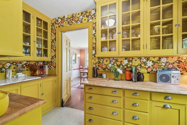 84 S Main St, Hanover, NH 03755 - kitchen featuring light countertops, wallpapered walls, glass insert cabinets, and carpet floors