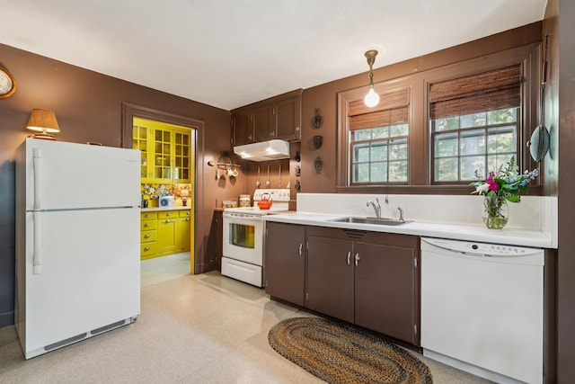84 S Main St, Hanover, NH 03755 - kitchen featuring white appliances, under cabinet range hood, light countertops, hanging light fixtures, and dark brown cabinets