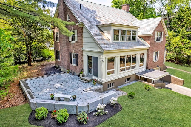 84 S Main St, Hanover, NH 03755 - rear view of house with a patio area, a high end roof, a lawn, and a chimney