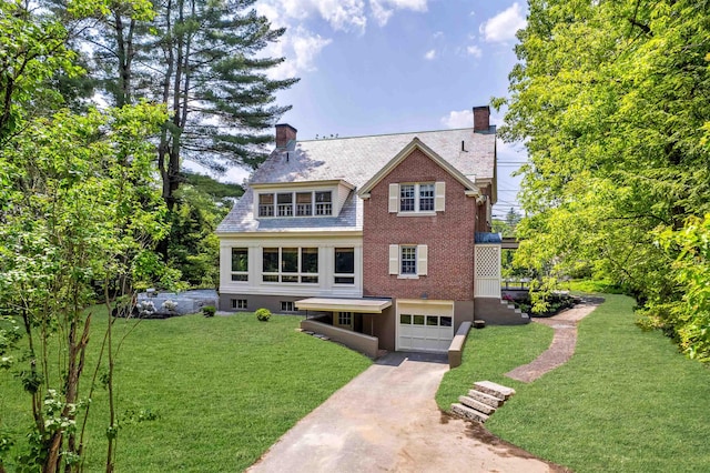 84 S Main St, Hanover, NH 03755 - view of front facade with concrete driveway, a chimney, an attached garage, and a front lawn