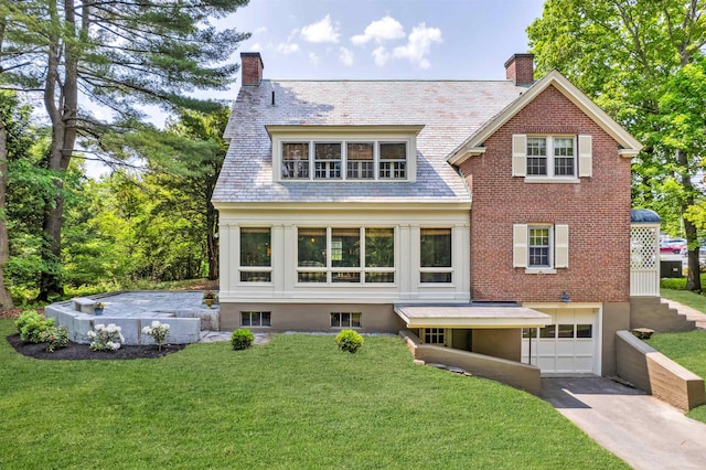 84 S Main St, Hanover, NH 03755 - view of front of property with a high end roof, a chimney, an attached garage, driveway, and a front lawn