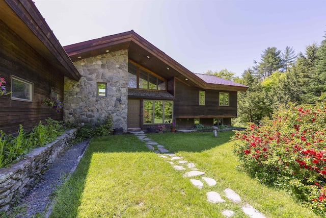 794 Sawnee Bean Rd, Thetford, VT 05075 - back of property with stone siding, a lawn, and a metal roof