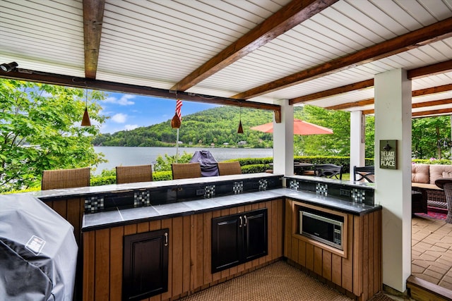 20 Bennett Cir, Antrim, NH 03440 - view of patio with a water view, exterior kitchen, and a wooded view