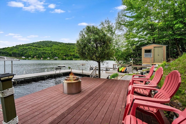 20 Bennett Cir, Antrim, NH 03440 - deck featuring a water view, a shed, a dock, a view of trees, and a fire pit
