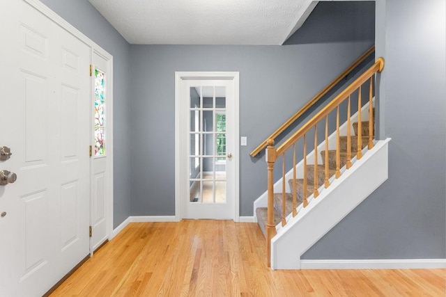 114 Byam Rd, New Boston, NH 03070 - entryway with stairs, wood finished floors, and a textured ceiling