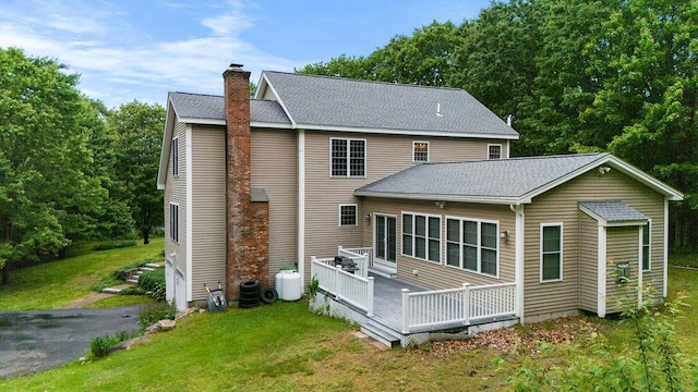 114 Byam Rd, New Boston, NH 03070 - rear view of house with a chimney, a lawn, a wooden deck, and a shingled roof