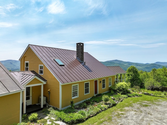 1074 N Hollow Rd, Rochester, VT 05767 - back of property featuring a standing seam roof, a metal roof, a chimney, and a mountain view