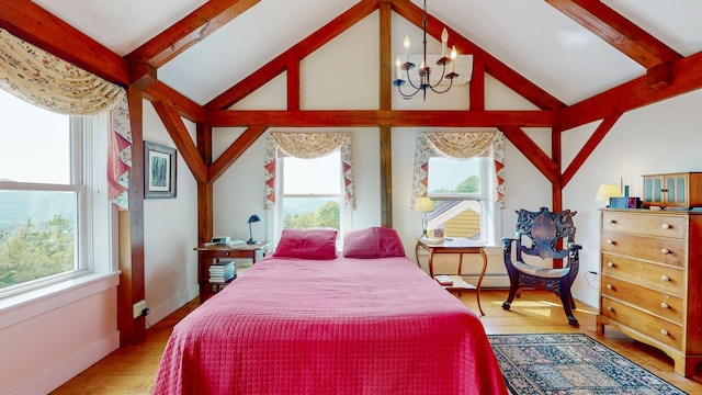 1074 N Hollow Rd, Rochester, VT 05767 - bedroom with multiple windows, wood finished floors, a chandelier, and a baseboard heating unit