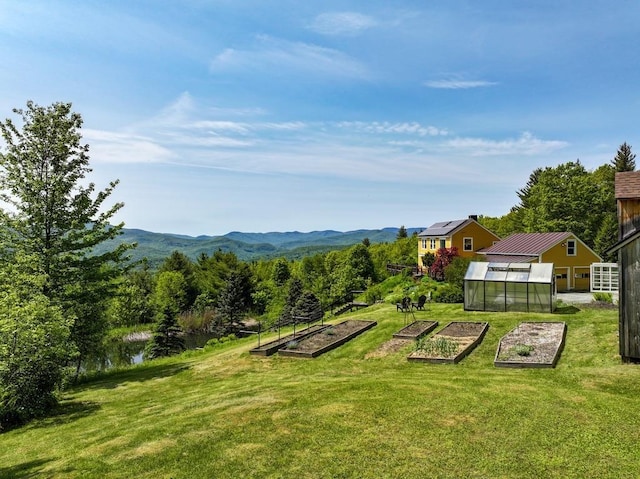 1074 N Hollow Rd, Rochester, VT 05767 - view of grassy yard with a vegetable garden, a greenhouse, an outbuilding, and a mountain view