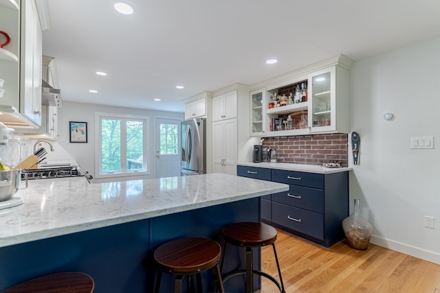 12 Garrison Ln, Madbury, NH 03823 - kitchen featuring open shelves, stainless steel fridge with ice dispenser, a kitchen bar, a peninsula, and recessed lighting