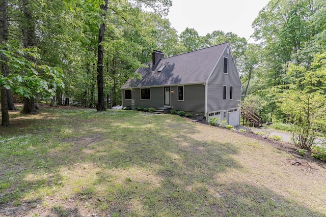 12 Garrison Ln, Madbury, NH 03823 - back of house featuring an attached garage, a chimney, and a shingled roof