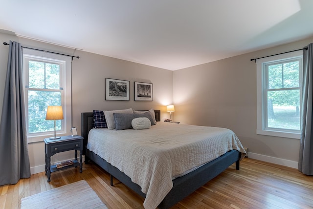 12 Garrison Ln, Madbury, NH 03823 - bedroom featuring light wood finished floors and multiple windows