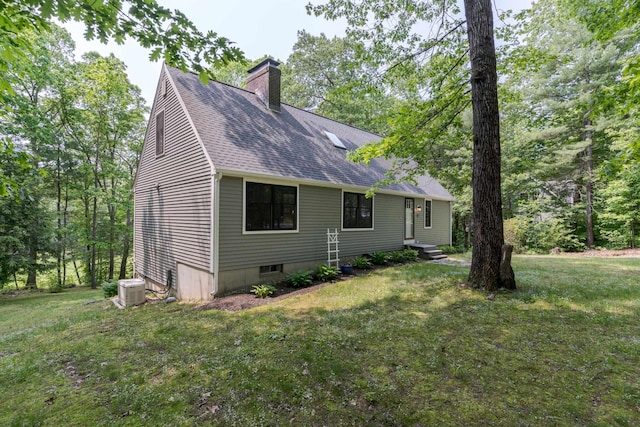 12 Garrison Ln, Madbury, NH 03823 - view of property exterior with a chimney, roof with shingles, and a lawn