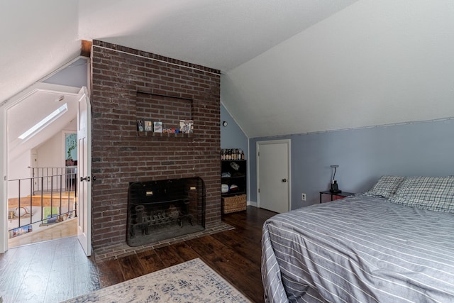 12 Garrison Ln, Madbury, NH 03823 - bedroom featuring vaulted ceiling, wood finished floors, and a fireplace