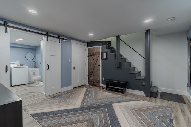 12 Garrison Ln, Madbury, NH 03823 - entryway featuring a barn door, washer / clothes dryer, wood finished floors, and recessed lighting
