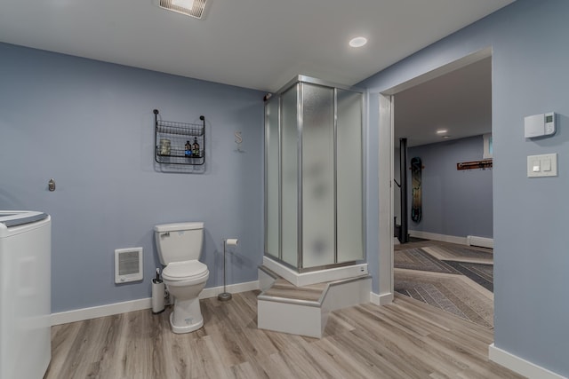 12 Garrison Ln, Madbury, NH 03823 - bathroom with a stall shower, washer / dryer, heating unit, wood finished floors, and recessed lighting