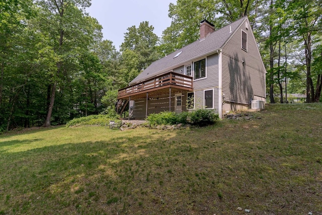 12 Garrison Ln, Madbury, NH 03823 - back of property featuring a wooden deck, a chimney, a lawn, and roof with shingles