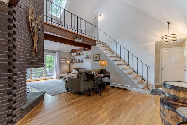 12 Garrison Ln, Madbury, NH 03823 - living area with baseboard heating, hardwood / wood-style flooring, a high ceiling, and stairs