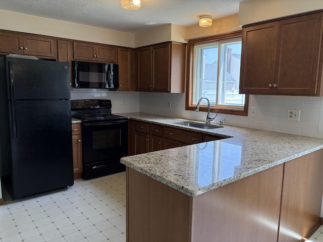 28 Old Orchard Way, Manchester, NH 03103 - kitchen with black appliances, a peninsula, tasteful backsplash, light stone countertops, and a textured ceiling