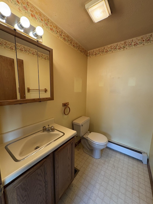 28 Old Orchard Way, Manchester, NH 03103 - half bath with a baseboard heating unit, vanity, tile patterned floors, and a textured ceiling