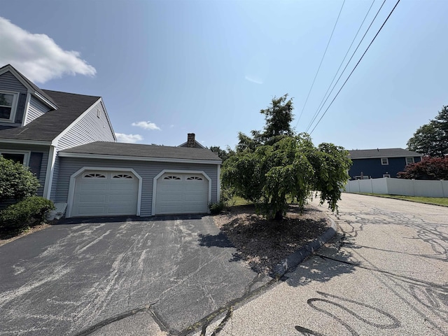 28 Old Orchard Way, Manchester, NH 03103 - view of front of house with asphalt driveway, an attached garage, and a chimney