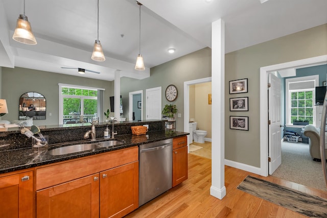 116 Piscataqua Rd Unit C, Durham, NH 03824 - kitchen with dishwasher, light wood-style floors, brown cabinetry, and dark stone countertops
