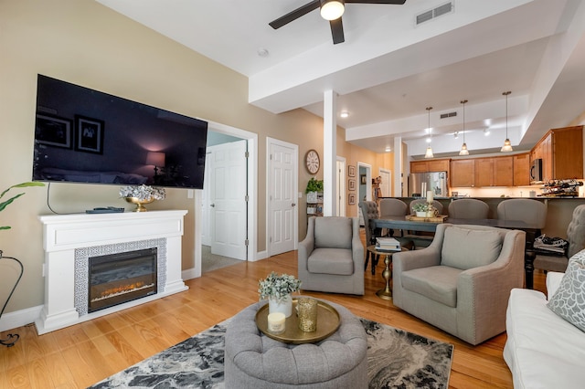116 Piscataqua Rd Unit C, Durham, NH 03824 - living area featuring light wood-style floors, ceiling fan, and a tiled fireplace