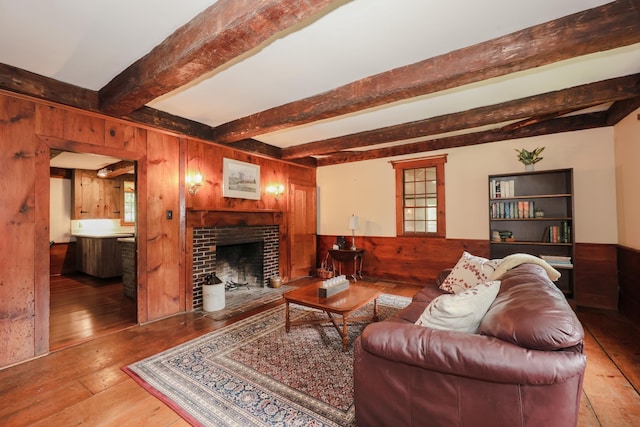 1448 Bound Tree Rd, Hopkinton, NH 03229 - living area with wood walls, hardwood / wood-style floors, beam ceiling, a fireplace, and wainscoting