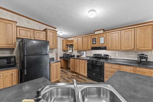 908 Gilbert Rd, Williamstown, VT 05679 - kitchen featuring black appliances, dark wood-style flooring, ornamental molding, dark countertops, and under cabinet range hood