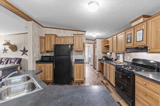 908 Gilbert Rd, Williamstown, VT 05679 - kitchen with black appliances, under cabinet range hood, dark countertops, dark wood-type flooring, and a textured ceiling