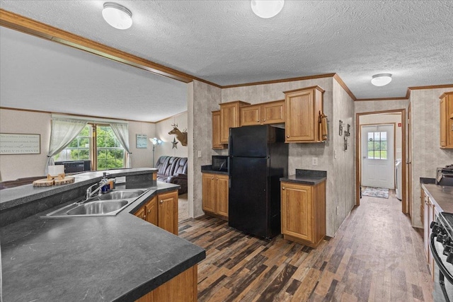 908 Gilbert Rd, Williamstown, VT 05679 - kitchen with black appliances, dark wood-style flooring, ornamental molding, a textured ceiling, and dark countertops