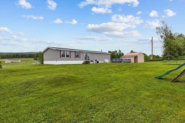 908 Gilbert Rd, Williamstown, VT 05679 - back of property featuring a lawn, an outdoor structure, and a playground