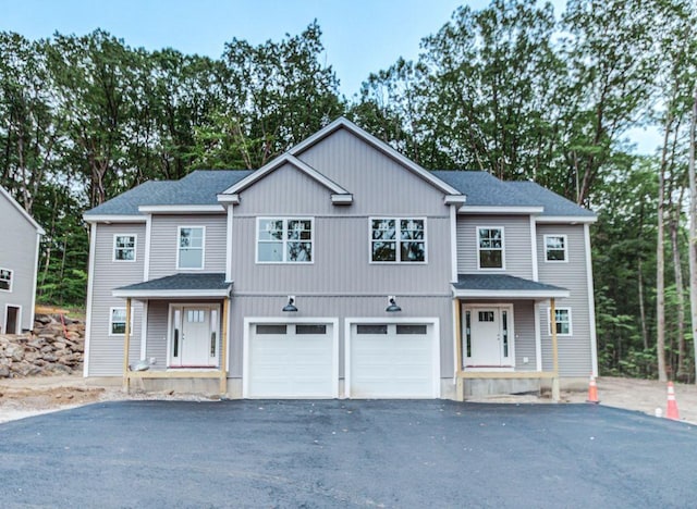 19 Speare Rd Unit B, Hudson, NH 03051 - view of property featuring driveway, a shingled roof, and a garage