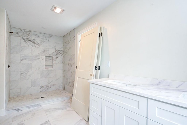 19 Speare Rd Unit B, Hudson, NH 03051 - bathroom featuring a tile shower, marble look tiles, and vanity