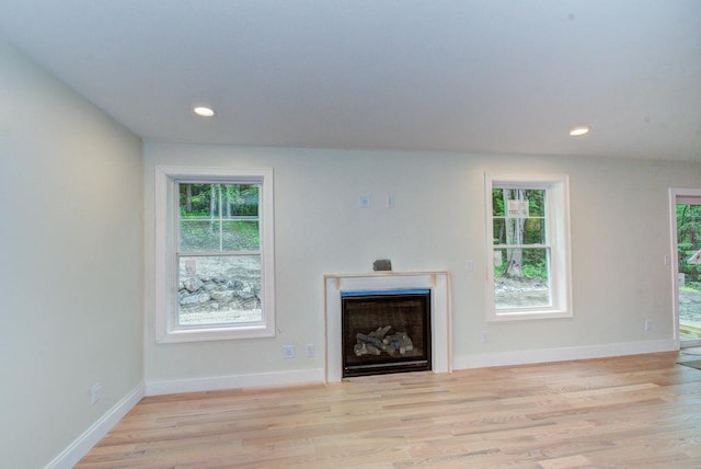 19 Speare Rd Unit B, Hudson, NH 03051 - unfurnished living room featuring a fireplace, wood finished floors, plenty of natural light, and recessed lighting