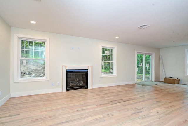 19 Speare Rd Unit B, Hudson, NH 03051 - unfurnished living room featuring light wood finished floors, a glass covered fireplace, and recessed lighting