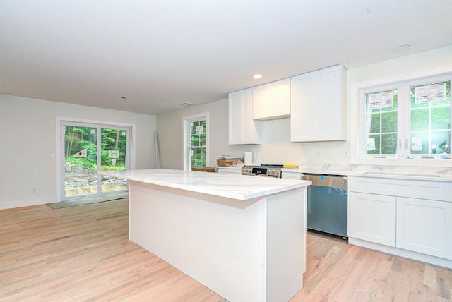 19 Speare Rd Unit B, Hudson, NH 03051 - kitchen featuring stainless steel dishwasher, a kitchen island, light wood finished floors, white cabinets, and range