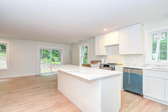 19 Speare Rd Unit B, Hudson, NH 03051 - kitchen with appliances with stainless steel finishes, a center island, light wood finished floors, white cabinets, and light stone counters