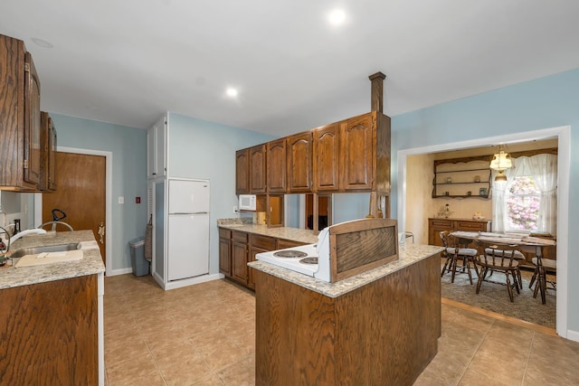 906 N Main St, Laconia, NH 03246 - kitchen with white appliances, a peninsula, brown cabinetry, light tile patterned flooring, and light stone countertops