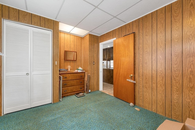 906 N Main St, Laconia, NH 03246 - bedroom with carpet flooring, wood walls, a closet, and a paneled ceiling