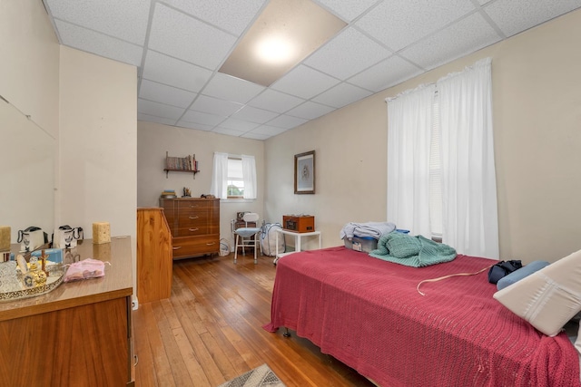 906 N Main St, Laconia, NH 03246 - bedroom featuring a paneled ceiling and hardwood / wood-style floors
