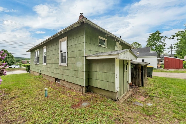 906 N Main St, Laconia, NH 03246 - view of home's exterior with a chimney and a yard