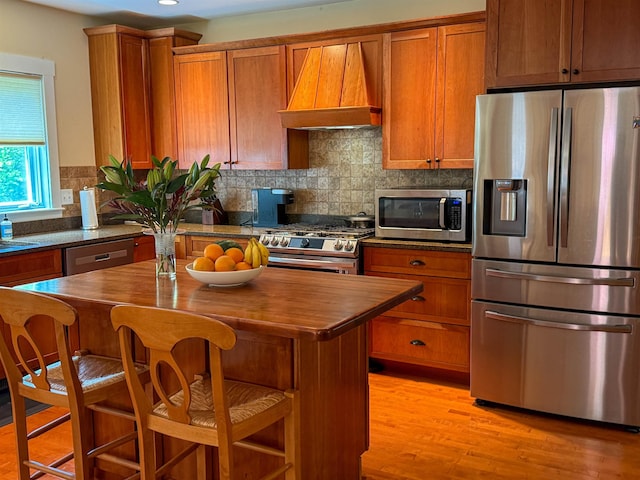 2 Parker Farm Ln, Amherst, NH 03031 - kitchen featuring stainless steel appliances, premium range hood, brown cabinets, wooden counters, and recessed lighting