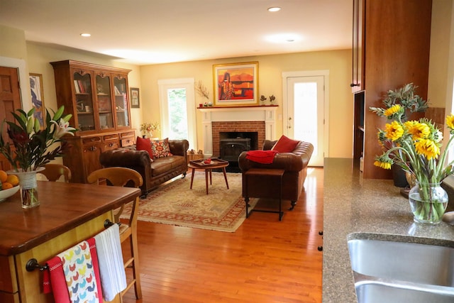 2 Parker Farm Ln, Amherst, NH 03031 - living area featuring light wood finished floors, recessed lighting, and a brick fireplace