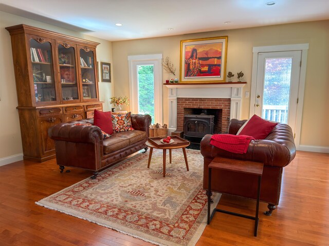 2 Parker Farm Ln, Amherst, NH 03031 - living area featuring wood finished floors, a wood stove, and recessed lighting