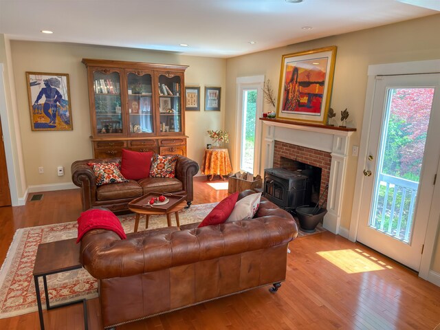 2 Parker Farm Ln, Amherst, NH 03031 - living room featuring a wood stove, wood finished floors, and recessed lighting
