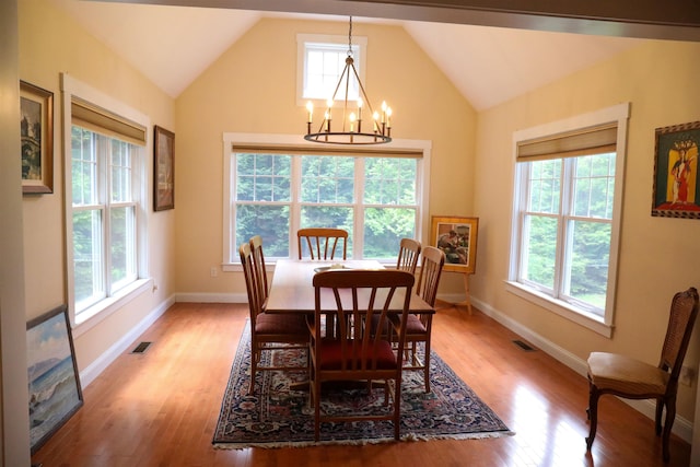 2 Parker Farm Ln, Amherst, NH 03031 - dining room featuring healthy amount of natural light, a chandelier, light wood finished floors, and high vaulted ceiling