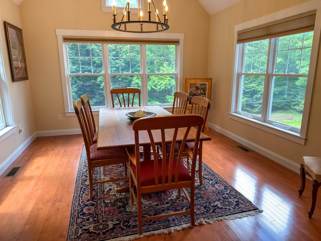 2 Parker Farm Ln, Amherst, NH 03031 - dining room featuring lofted ceiling, light wood-style flooring, and a chandelier